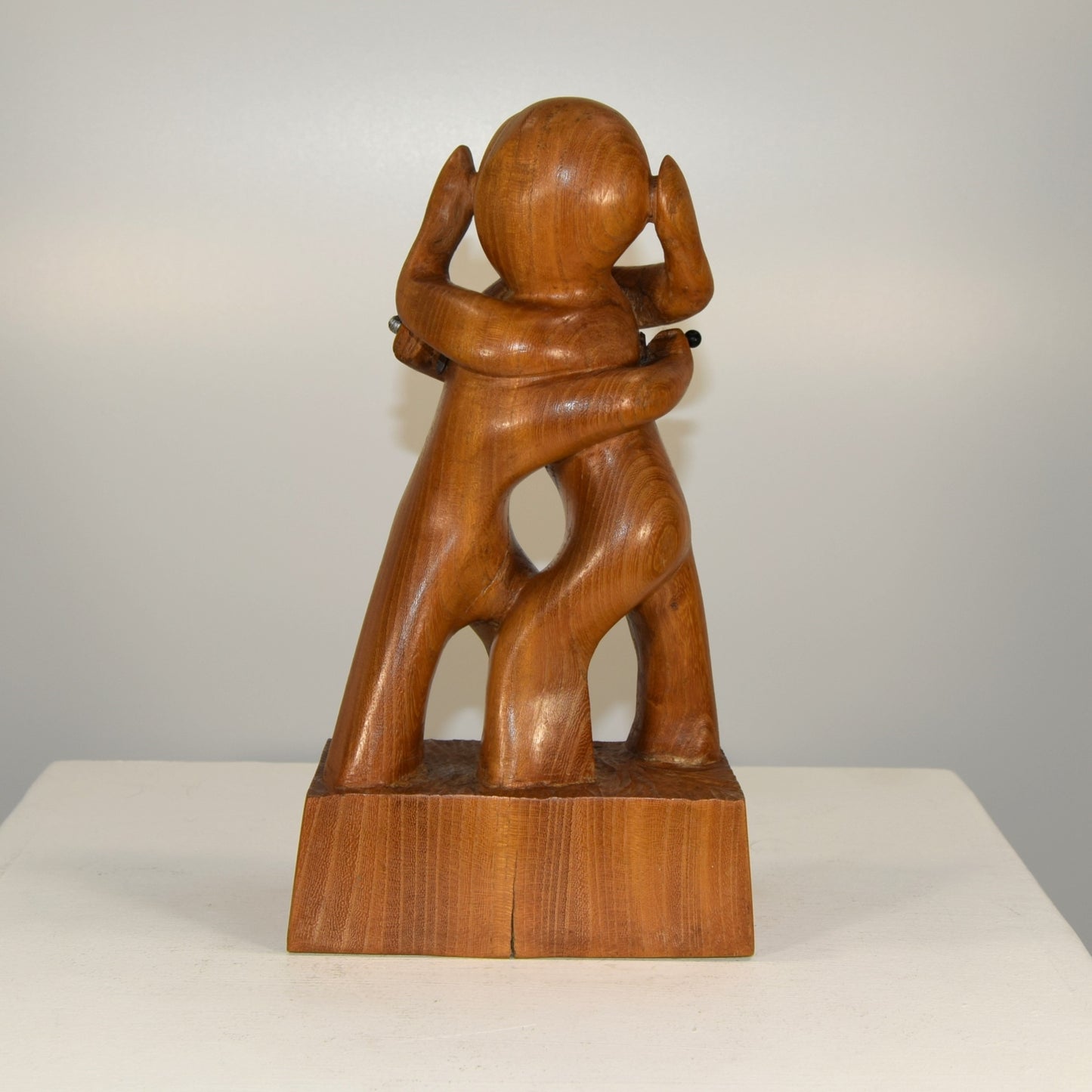 Abstract Embracing Backstabbing Figures in Oak